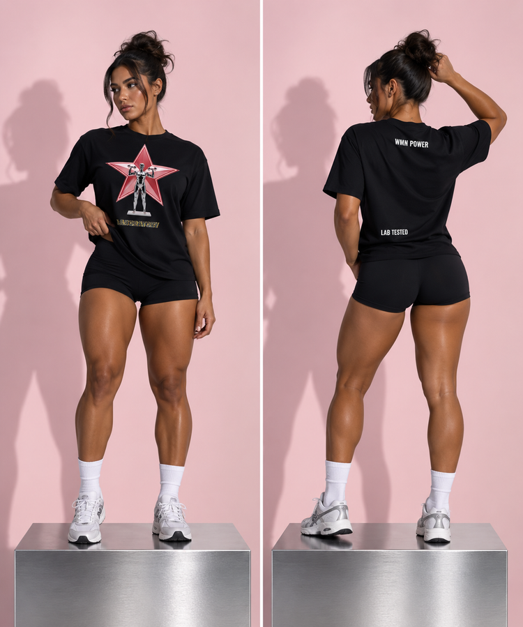 A model is shown from both front and back wearing a black LA Testers t-shirt with a red star graphic on the front and white text on the back, paired with black athletic shorts, white socks, and white sneakers, standing on a metallic platform against a pink background.