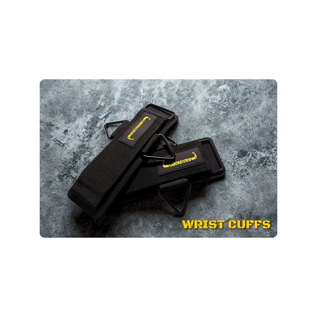 LABORATORY Black wrist cuffs with a brand logo on a gray textured background, labeled 'Wrist Cuffs'.