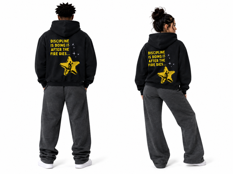 Two models shown from the back wearing matching black hoodies with a yellow graphic and text on the back, paired with dark gray sweatpants, on a white studio background.