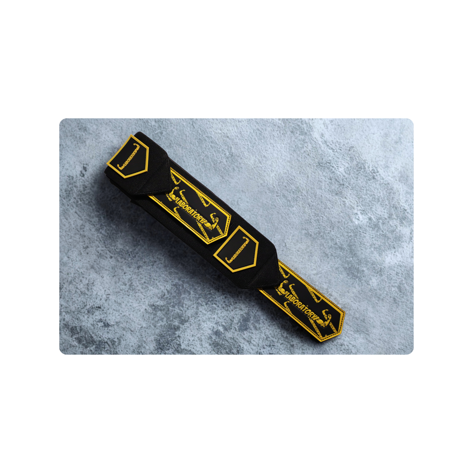 Black and yellow laboratory wrist wrap V2  a textured gray surface