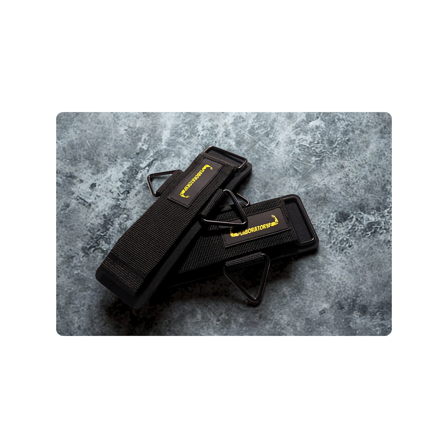 LABORATORY Black WRIST CUFFS with yellow branding on a gray textured background