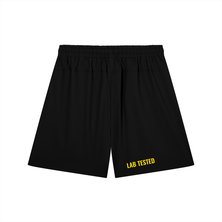 Black athletic shorts with an elastic waistband and yellow 'LAB TESTED' text printed on the lower left leg, shown against a plain white background.