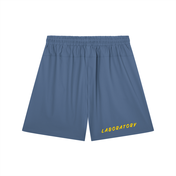 Blue athletic shorts with an elastic waistband and yellow 'LABORATORY' text printed on the lower left leg, shown against a plain white background.