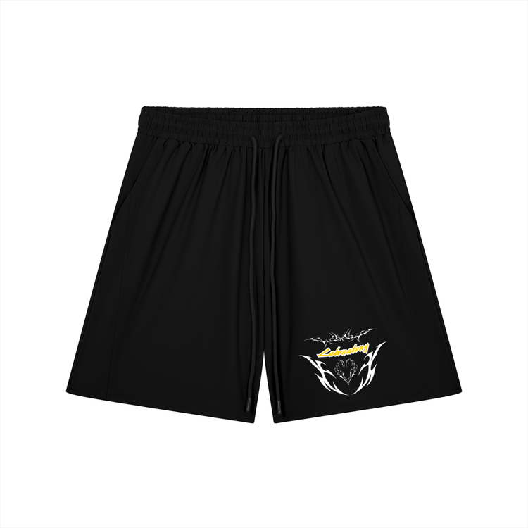 Black athletic shorts with an elastic waistband and a small graphic print on the lower left leg featuring a yellow and white design.