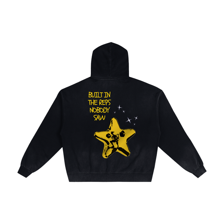 A black cropped hoodie shown from the back, featuring a yellow graphic of a star with a skeleton inside and the text 'BUILT IN THE REFS NOBODY SAW' in yellow.
