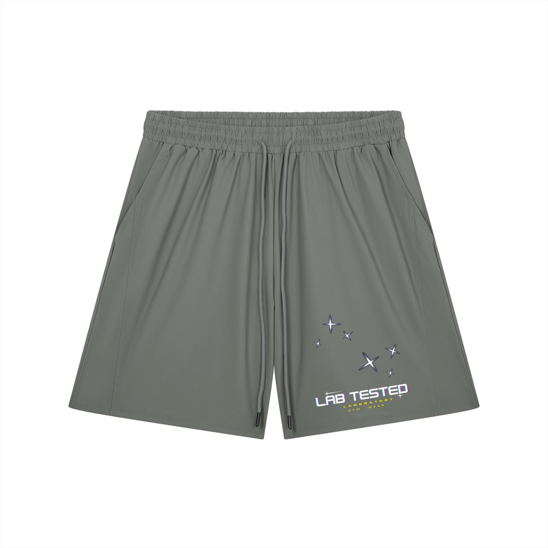 A pair of gray athletic shorts with an elastic waistband and drawstring, featuring a small graphic on the lower left leg with the text 'LAB TESTED' and star illustrations, displayed on a solid white background.