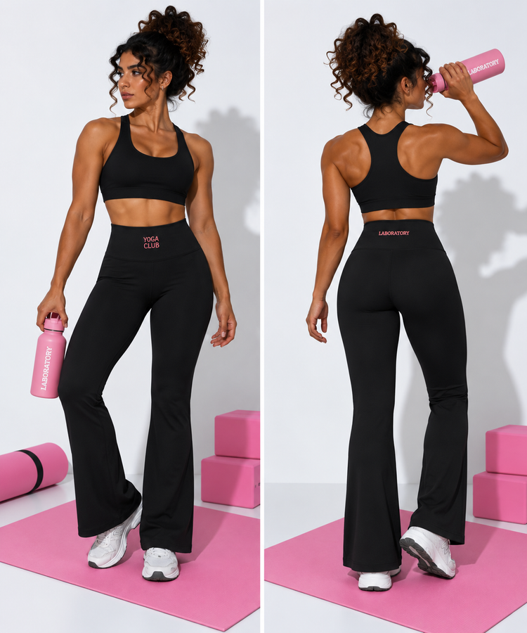 A woman modeling a black yoga set in a studio setting, shown from both the front and back. The set includes a black sports bra and high-waisted black flared yoga pants with 'YOGA CLUB' printed in pink on the waistband.